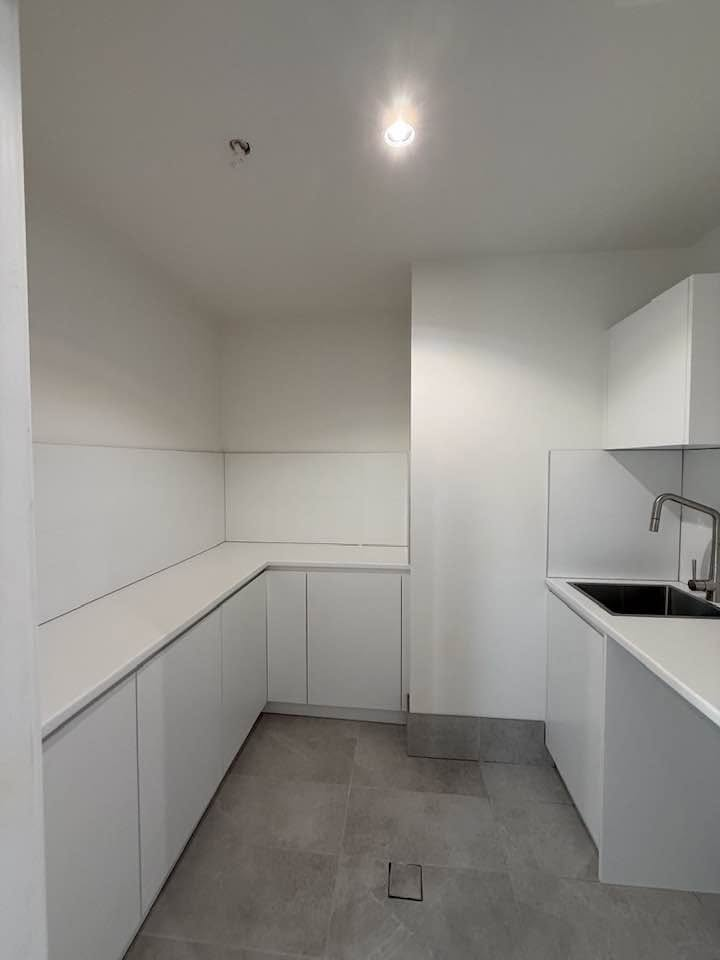Compact white laundry cabinetry