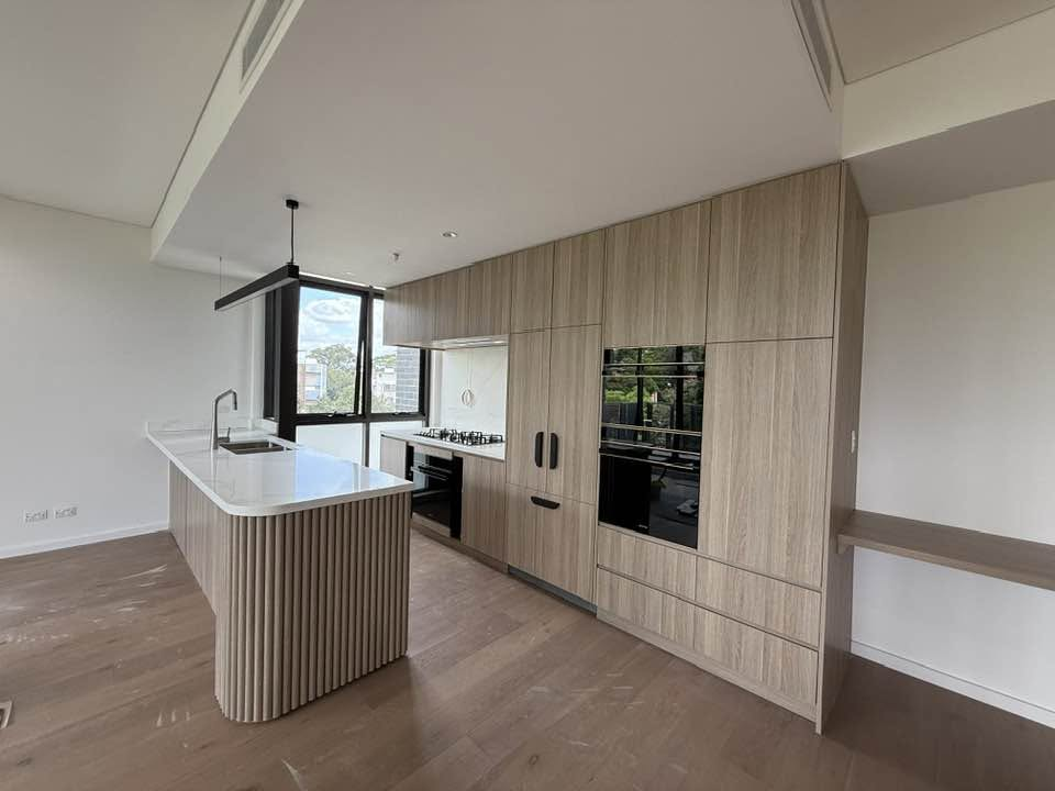Light wood kitchen joinery with island and integrated appliances