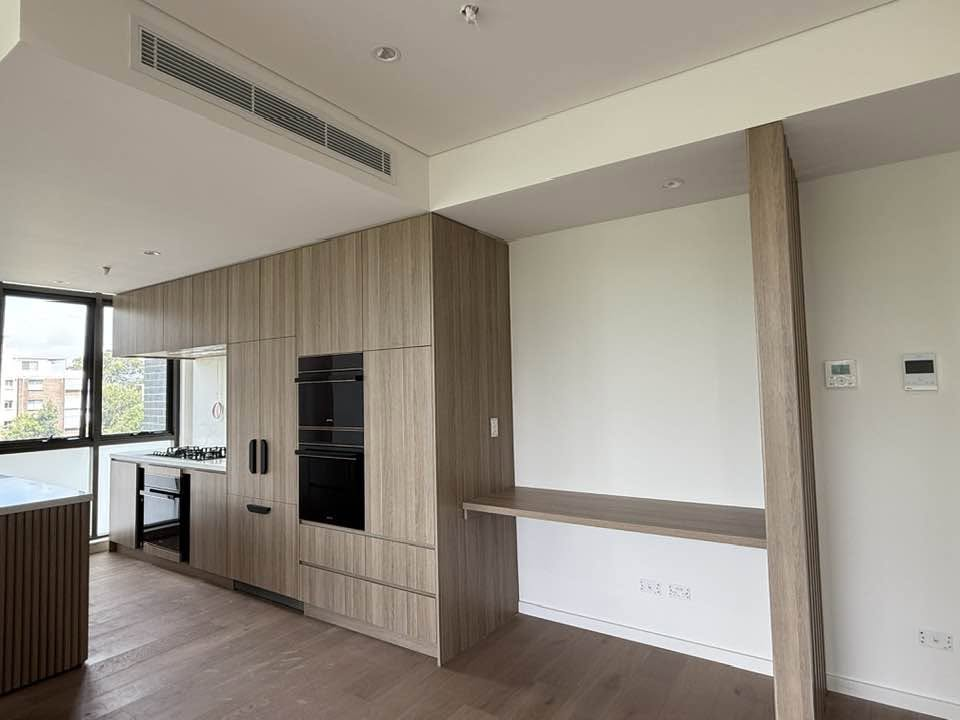 Light timber kitchen cabinetry with adjacent bench
